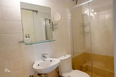 a bathroom with a toilet and a sink and a mirror at Aphrodite - Cozy & Bright Studio in Egaleo-Athens in Athens