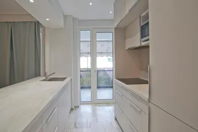 a kitchen with white cabinets and a counter top at Belle Helene Luxury, Fully Reno, Athenian Riviera in Athens