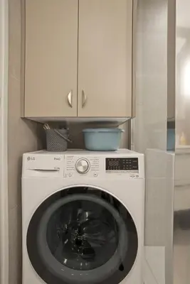 a white washing machine with a cabinet above it at Belle Helene Luxury, Fully Reno, Athenian Riviera in Athens