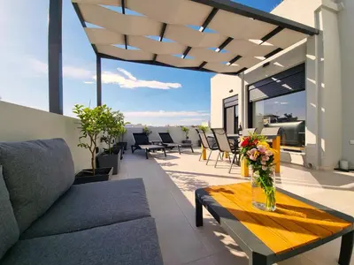 a patio with a vase of flowers on a table at 10 Apartments & Suites Athens in Athens