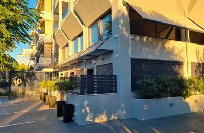 a building with potted plants on the side of it at 10 Apartments & Suites Athens in Athens