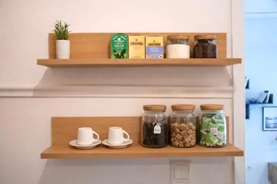 a pantry shelf with jars of food and ingredients at Modern Apartment in Cholargos in Athens