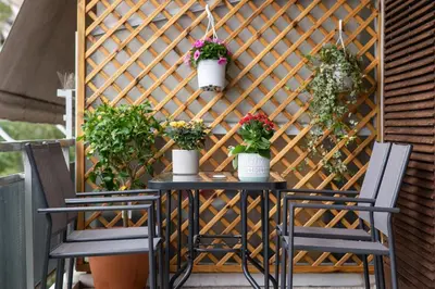 a wooden wall with potted plants on a patio at Modern Apartment in Cholargos in Athens