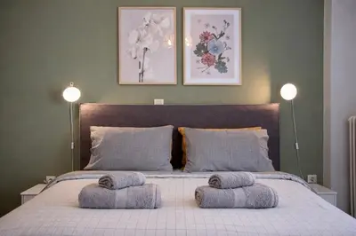 a bedroom with a bed with two pillows on it at Modern Apartment in Cholargos in Athens