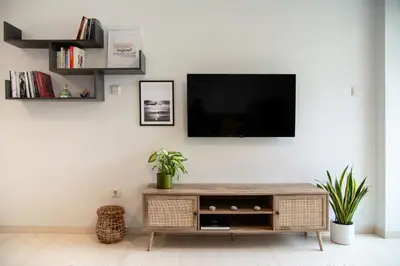 a living room with a television on a white wall at Modern Apartment in Cholargos in Athens
