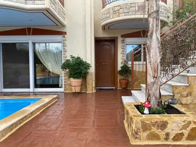 a house with a balcony and a swimming pool at Pool Garden House near the Sea in Vari