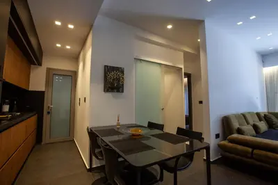 a kitchen and dining room with a table and a couch at Carmen's cozy&luxury apartment! in Athens