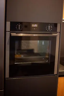 a black oven with its door open in a kitchen at Carmen's cozy&luxury apartment! in Athens