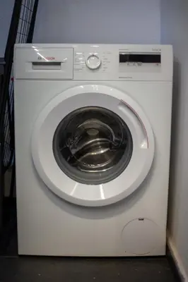 a white washing machine sitting in a room at Carmen's cozy&luxury apartment! in Athens