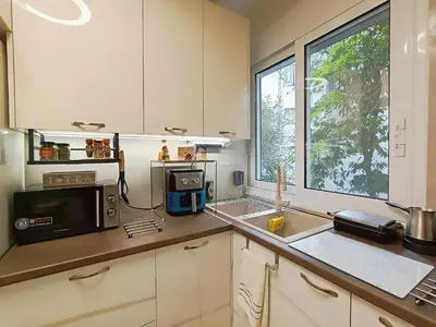 a kitchen with a sink and a microwave at Dimelli's Home in Athens - Comfort & Style Stay in Athens