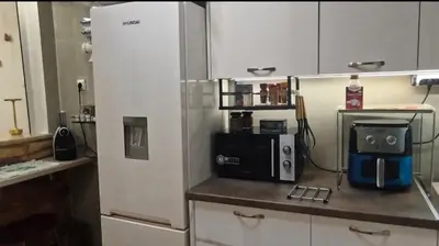 a kitchen with a refrigerator and a microwave at Dimelli's Home in Athens - Comfort & Style Stay in Athens