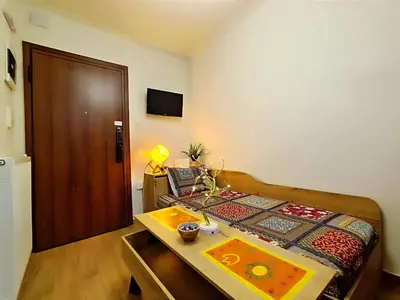 a bedroom with a bed and a table and a door at Dimelli's Home in Athens - Comfort & Style Stay in Athens