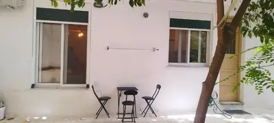 a group of chairs sitting outside of a building at Dimelli's Home in Athens - Comfort & Style Stay in Athens