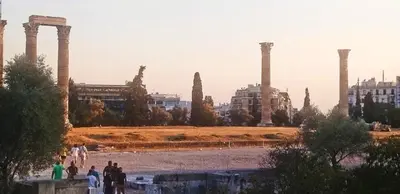 a group of people walking in front of a temple at Dimelli's Home in Athens - Comfort & Style Stay in Athens