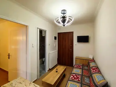 a room with a bed and a table in it at Dimelli's Home in Athens - Comfort & Style Stay in Athens