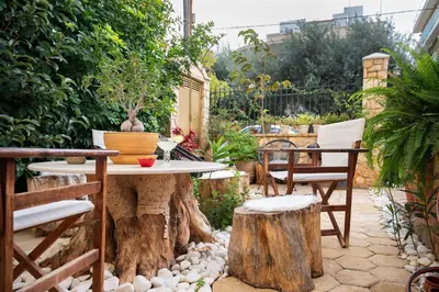a patio with a table and chairs and trees at Artistic Villa Luxury in Athens