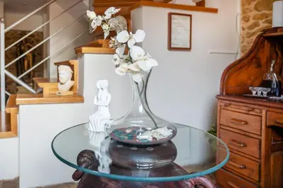 a glass vase with white flowers on a glass table at Artistic Villa Luxury in Athens
