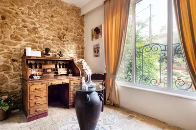 a room with a table and a stone wall at Artistic Villa Luxury in Athens