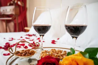 two glasses of red wine and a plate of food at Artistic Villa Luxury in Athens