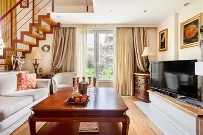 a living room with a television and a table at Artistic Villa Luxury in Athens