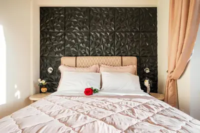 a bedroom with a large bed with a flower on it at Artistic Villa Luxury in Athens