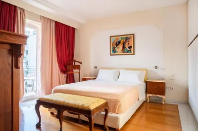 a hotel room with a bed and a window at Artistic Villa Luxury in Athens