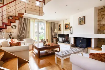 a living room with a couch and a fireplace at Artistic Villa Luxury in Athens