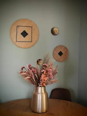 a vase on a table with flowers in it at Caravin Wanderhome Acropolis, 1 min from Acropolis Museum in Athens