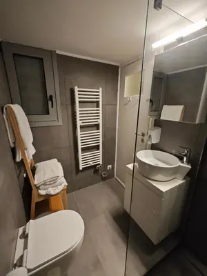 a small bathroom with a toilet and a sink at Caravin Wanderhome Acropolis, 1 min from Acropolis Museum in Athens