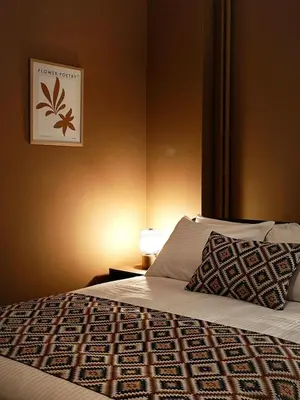 a bedroom with a bed and a picture on the wall at Caravin Wanderhome Acropolis, 1 min from Acropolis Museum in Athens