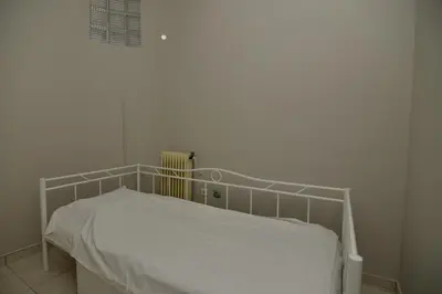 a white bed in a white room with at Athenian Riviera Beach front apartment 2 minutes from Tram stop in Athens