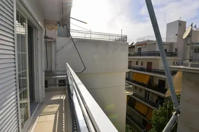 an apartment balcony with a view of a building at Athenian Riviera Beach front apartment 2 minutes from Tram stop in Athens
