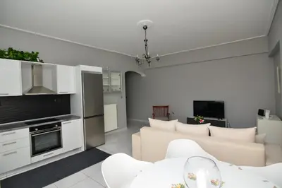 a living room with a couch and a table at Athenian Riviera Beach front apartment 2 minutes from Tram stop in Athens