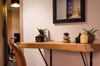 a wooden table with plants and a picture on the wall at STAMOS Apartment airport in Spáta