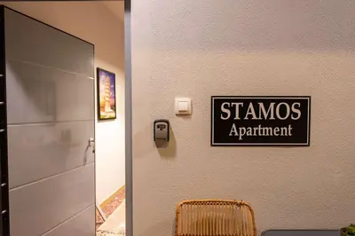 a sign that reads stannis apartment on a wall next to a door at STAMOS Apartment airport in Spáta