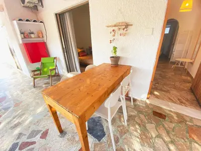 a wooden table in the middle of a room at The Beachhouse Apartments in Vaia