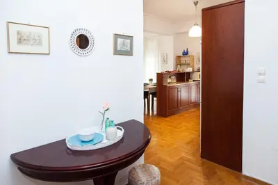 a living room with a table and a kitchen at Anastasia apts Athina in Athens