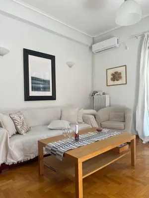 a living room with a couch and a table at Anastasia apts Athina in Athens