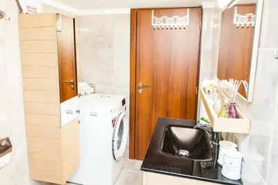 a small bathroom with a washing machine in it at Anastasia apts Athina in Athens