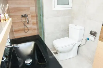 a bathroom with a toilet and a sink at Anastasia apts Athina in Athens