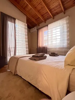 a bedroom with a large bed with two towels on it at Sunny Athens in Athens