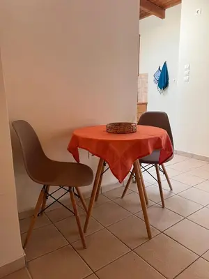 a table and two chairs with a red table cloth on it at Sunny Athens in Athens