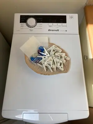 a bowl of toothbrushes is sitting on top of a washing machine at Sunny Athens in Athens