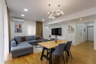a living room with a table and a couch at Magnificent Riviera Residence VIPGreece in Athens