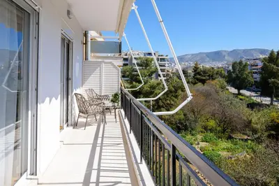 a balcony of a house with two chairs at Magnificent Riviera Residence VIPGreece in Athens