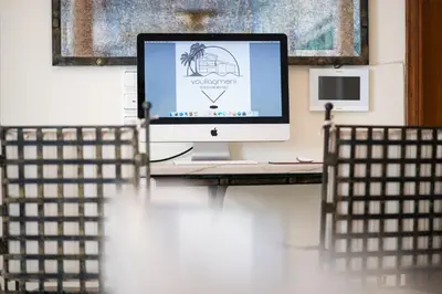 a computer monitor sitting on a desk in a room at Vouliagmeni Athenian Riviera Villa in Athens