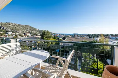a balcony with a table and two chairs on it at Vouliagmeni Athenian Riviera Villa in Athens