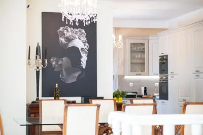 a dining room with a table and a chandelier at Vouliagmeni Athenian Riviera Villa in Athens