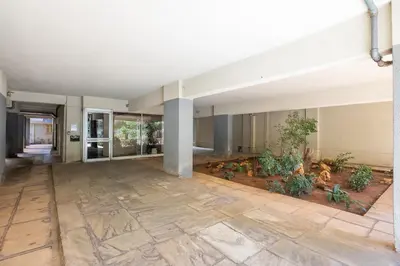 an empty lobby of a building with plants at Santorini 2-Bedroom Apartment in Nea Smyrni in Athens
