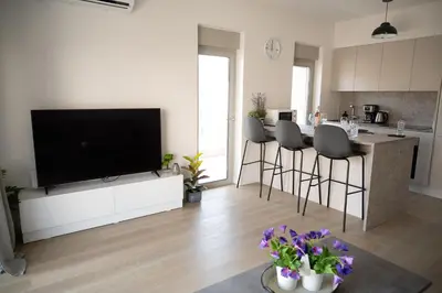 a kitchen and living room with a flat screen tv at Elegant and cozy flat near Pagrati region (D1) in Athens